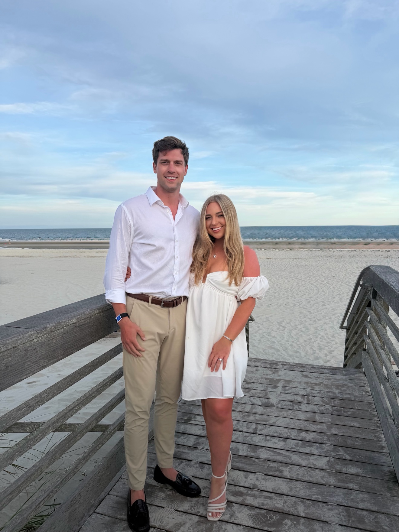 Gentry Gevers and his wife together on a beach boardwalk