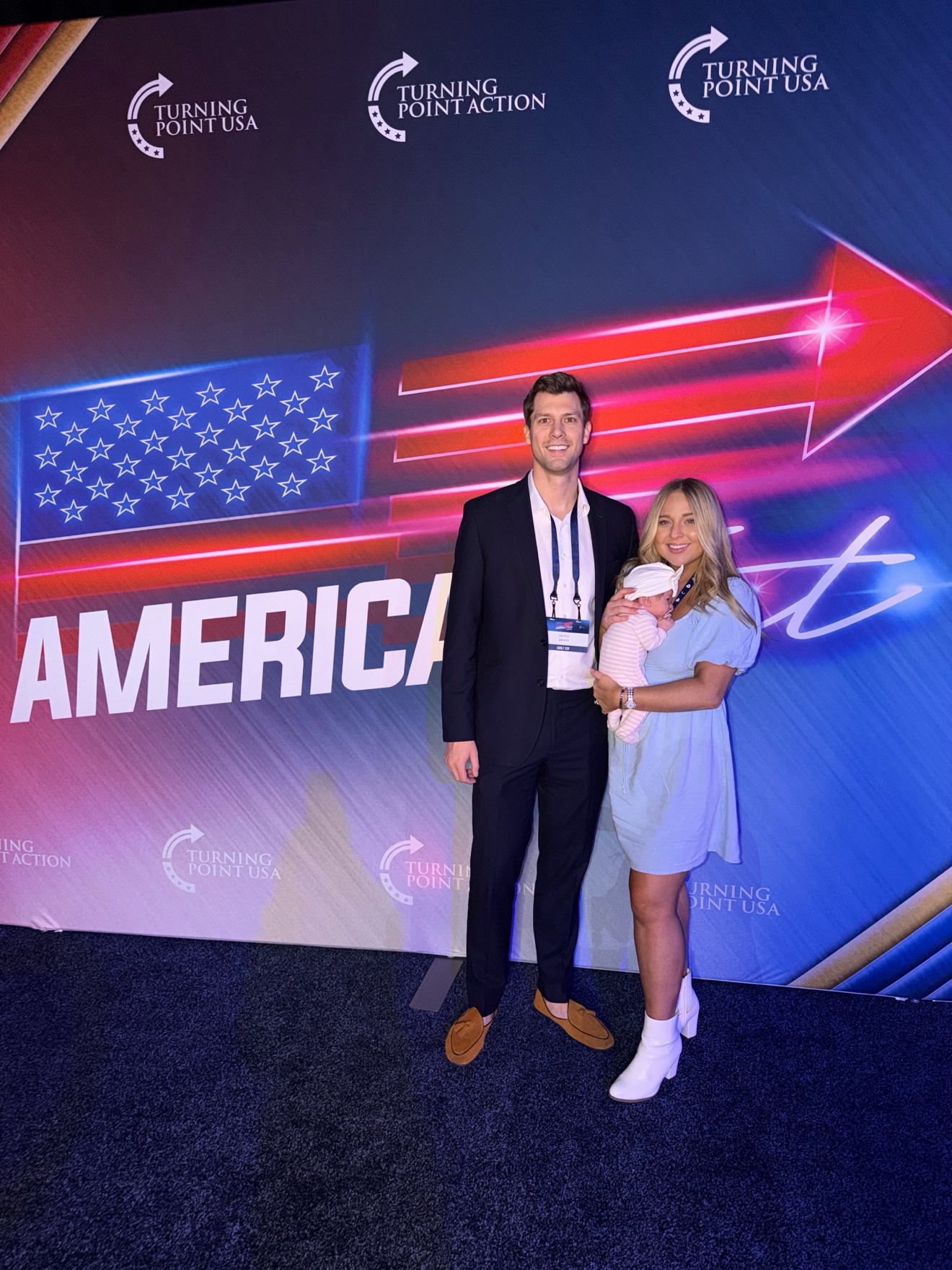 Gentry and his wife with their baby at a Turning Point USA event